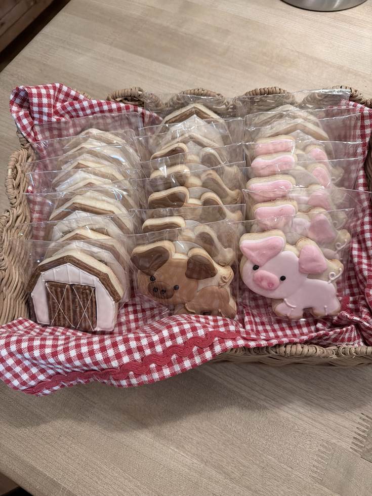 Barn, cow and pig cookies individually wrapped in a gingham lined basket at The Barn Door