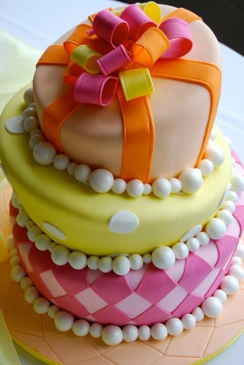 Pastel gift box shaped birthday cake with ribbon bow and pearls