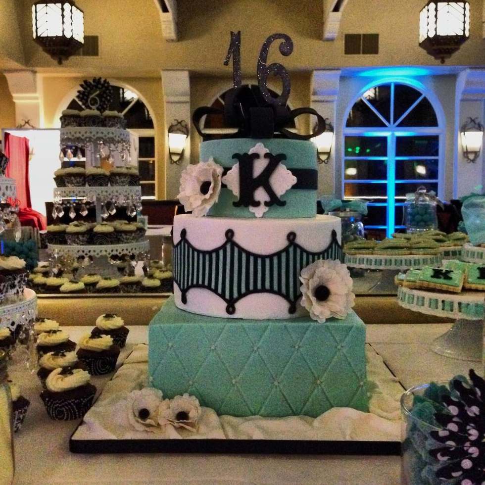 Teal black and white Sweet 16 cake with a monogram and dessert table