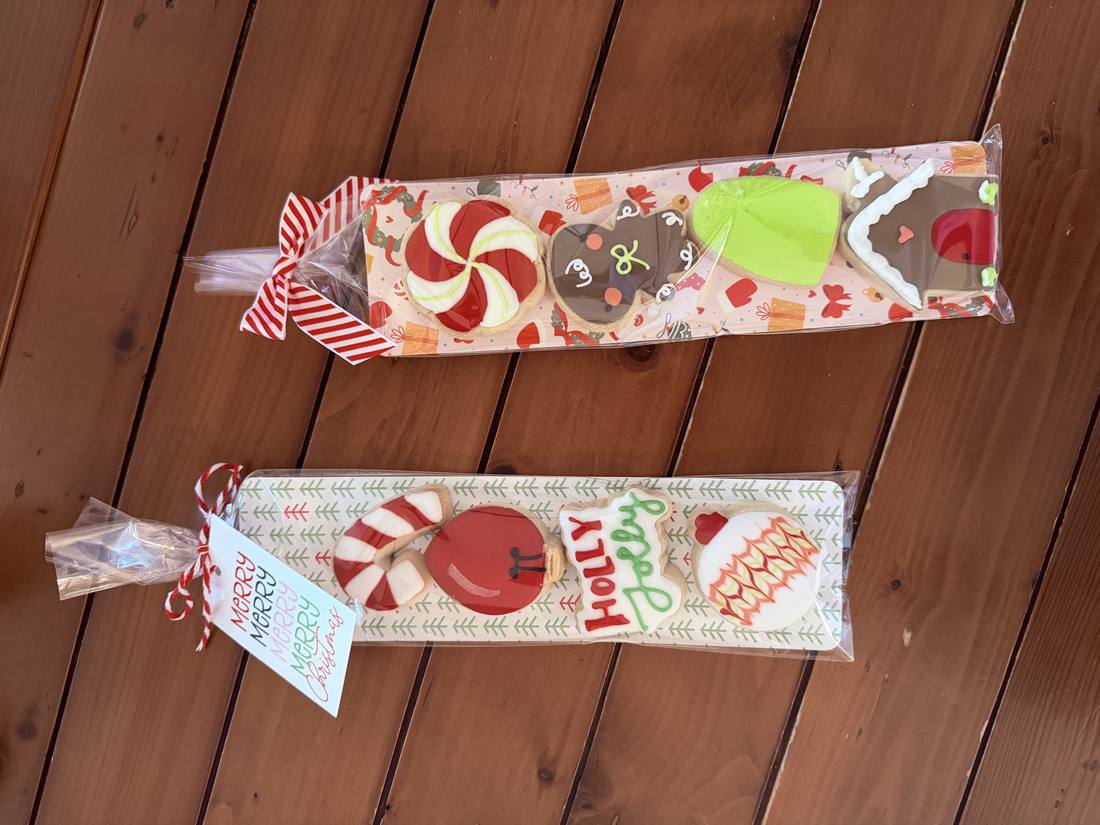 Christmas cookie gift sleeves tied with ribbon and holiday tags